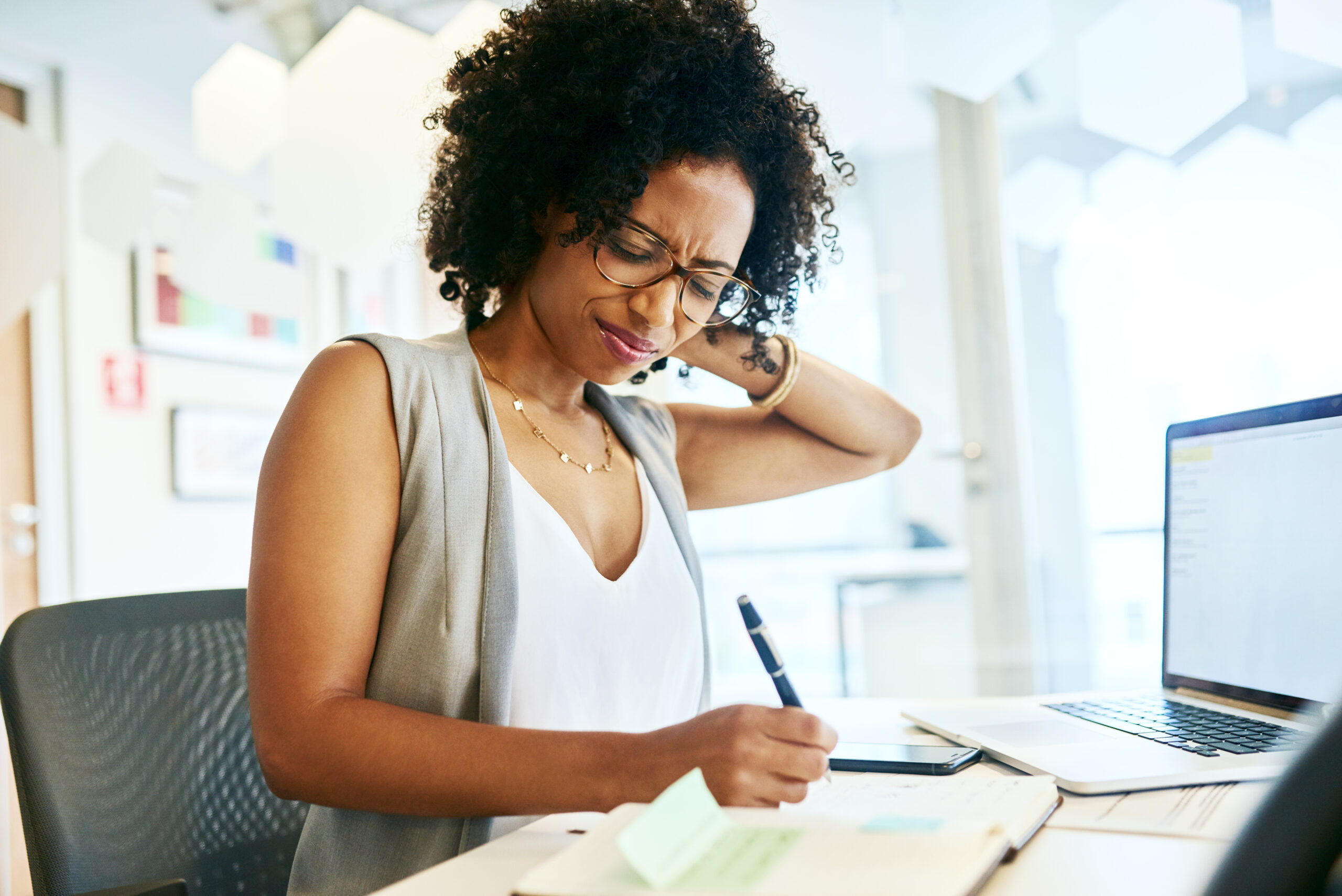 Cropped shot of a businesswoman suffering from neck pain in need of a Marietta personal injury lawyer